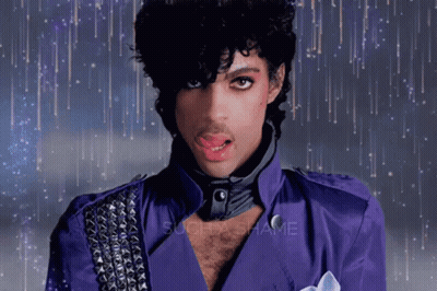 Prince Wearing A Purple Jacket With Studs On The Sleeves GIF