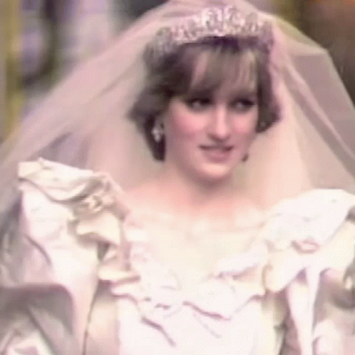 Princess Diana Is Wearing A White Wedding Dress And Veil And A Tiara . GIF