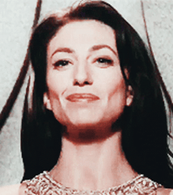 Proud Claudia Black Demure Smile GIF