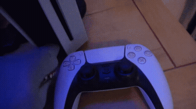 PS5 Controller On Wooden Floor GIF