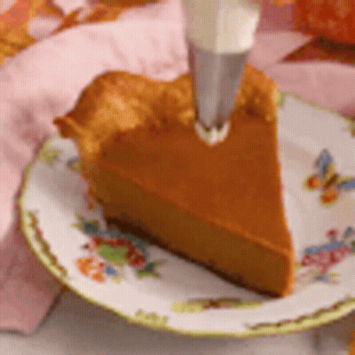 Pumpkin Pie With Whipped Cream Being Piped GIF