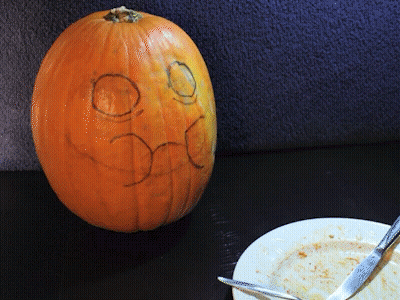 Pumpkin With Drawn Face And Plate Of Food GIF