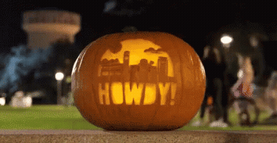 Pumpkin With Howdy Carved On Sidewalk GIF