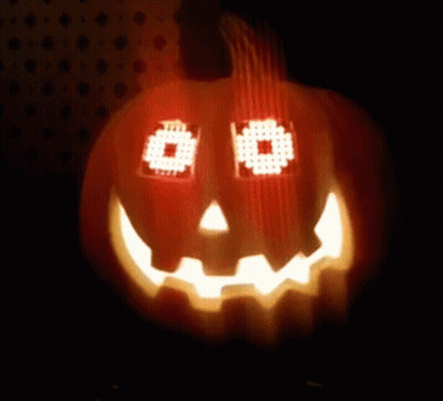 Pumpkin With Pixelated Face Lit In Dark GIF