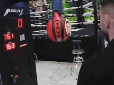 Punching Bag With Man Hanging From Crawler GIF