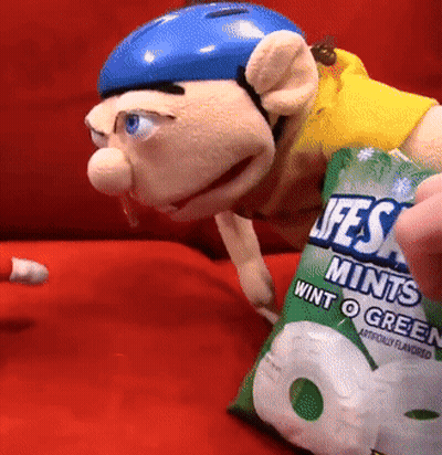 Puppet In Blue Helmet Holding Lifesaver Mints GIF