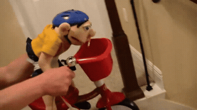 Puppet In Blue Helmet Riding Red Bicycle With Basket GIF