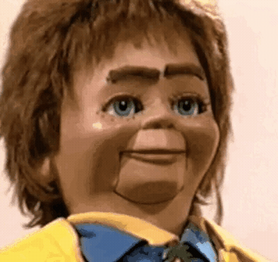 Puppet In Yellow Jacket, Blue Shirt And Tie GIF