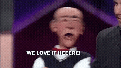 Puppet Saying We Love It Heere In Front Of Man In Suit GIF