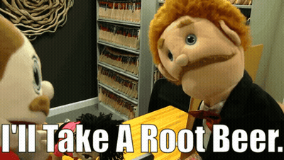 Puppet Says I'll Take A Root Beer Sitting At Table GIF