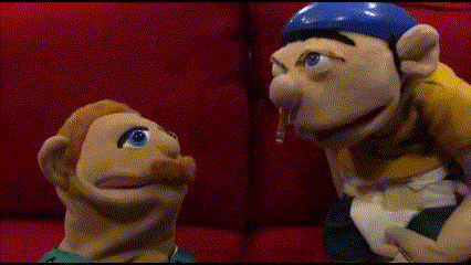Puppet Sitting On Red Couch With Blue Hat GIF