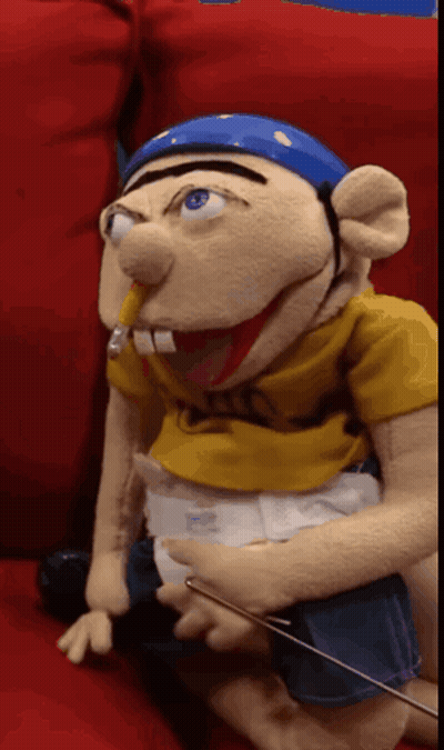 Puppet With Diaper Sitting On Couch GIF