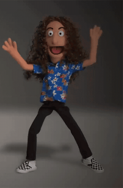 Puppet With Long Curly Hair In Blue Shirt And Checkered Shoes GIF
