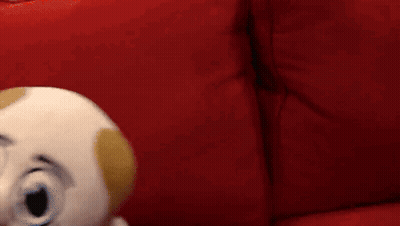 Puppet With Mustache On Red Couch GIF
