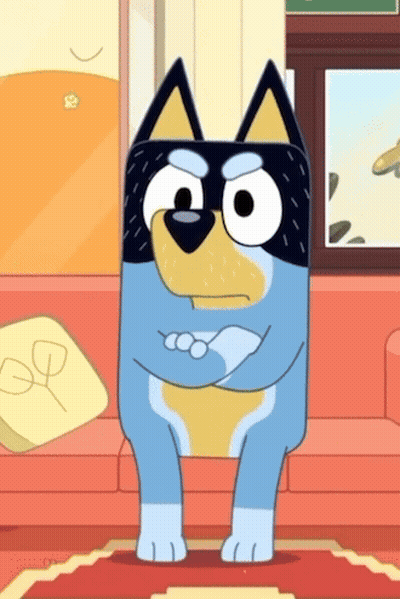 Puppy Sitting On Tiled Floor With Ball In Mouth GIF