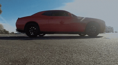 Purple Car Driving Past Speed Limit Sign In Parking Garage GIF