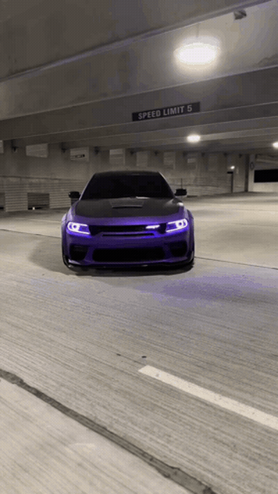 Purple Car Driving Under Speed Limit Sign In Parking Garage GIF