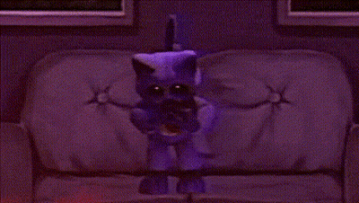 Purple Cat Standing On Couch Holding Crescent Moon GIF