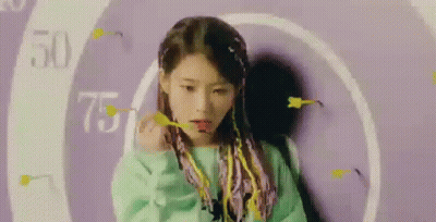 Purple-Haired Girl Holding Dart By Purple Wall GIF