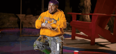 Purple-Haired Man In Yellow Hoodie Sitting GIF