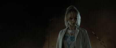 Purple-Haired Woman Glowing In Dark GIF