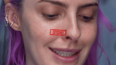 Purple Haired Woman With Canceled Stamp On Face GIF