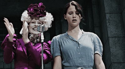 Purple Jacket Woman Next To Blue Shirt Woman Holding Microphone GIF