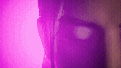 Purple-Lit Woman Face Close-Up GIF