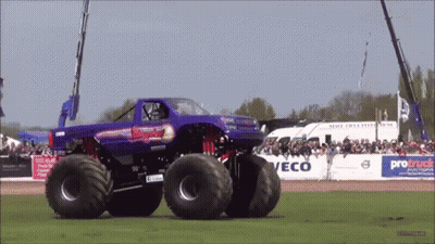 Purple Monster Truck Drives Past Crowd Protruck Sign GIF
