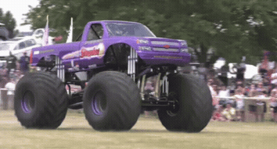Purple Monster Truck Driving In Front Of Crowd GIF