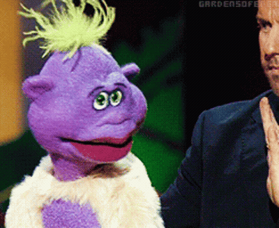 Purple Puppet With Green Mohawk Next To Man In Suit GIF