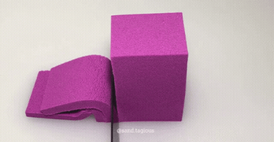 Purple Sand Cube Cut In Half By Ruler GIF