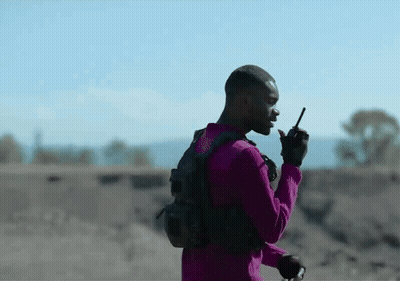 Purple Shirt Man Talking On Walkie Talkie Desert GIF