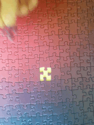 Putting Last Piece Of Colorful Jigsaw Puzzle GIF
