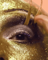 Putting On Gold Fake Eyelashes  GIF