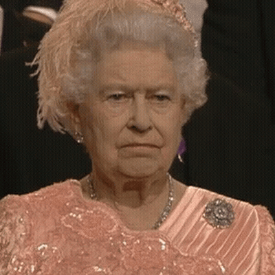 Queen Elizabeth II In Pink Dress And Feathered Hat GIF