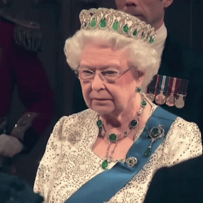 Queen Elizabeth Is Wearing A Tiara And A Blue Sash GIF