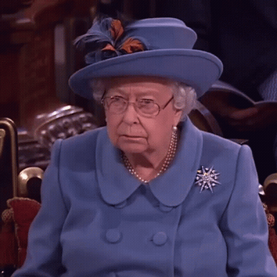 Queen Elizabeth Wearing A Blue Coat And Hat With Feathers GIF