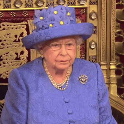 Queen Elizabeth Wearing A Blue Hat With Yellow Flowers On It GIF