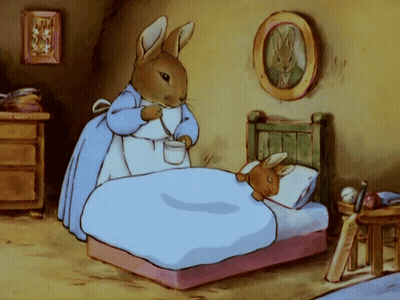 Rabbit Standing Next To Bed Holding Cup GIF