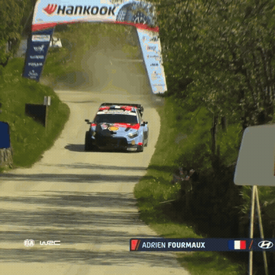 Race Car Driving Down Dirt Road With Hankook Sign
