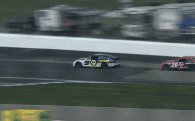 Race Car Driving Down Track With Cars Behind GIF