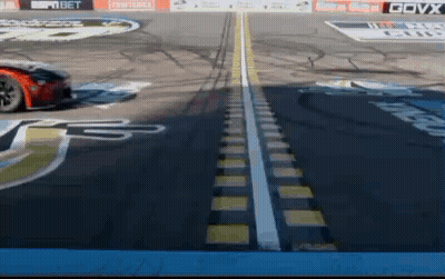 Race Car Driving On Track With GOVX Logo GIF