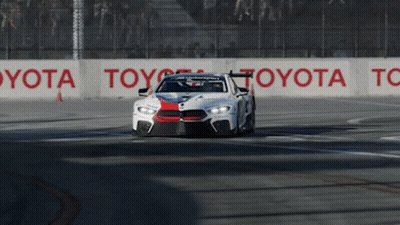 Race Car Driving On Track With Toyota Sign GIF
