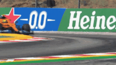 Race Car Driving Past Heineken Sign GIF