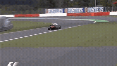 Race Car Going Around Curve With Bridgestone Sign GIF