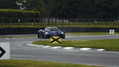Race Car Going Around Curve With Yellow X GIF