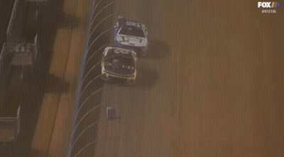 Race Car Going Around Track With Zmax Sign GIF