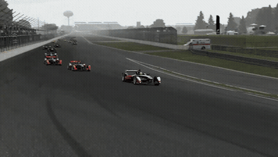 Race Car Going Down Track With Fence GIF
