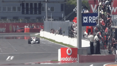 Race Car Going Down Track With Vodafone Sign GIF